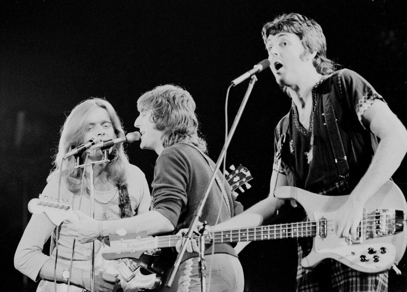 Henry McCullough, Denny Laine, and Paul McCartney of Wings performing in France in 1972.