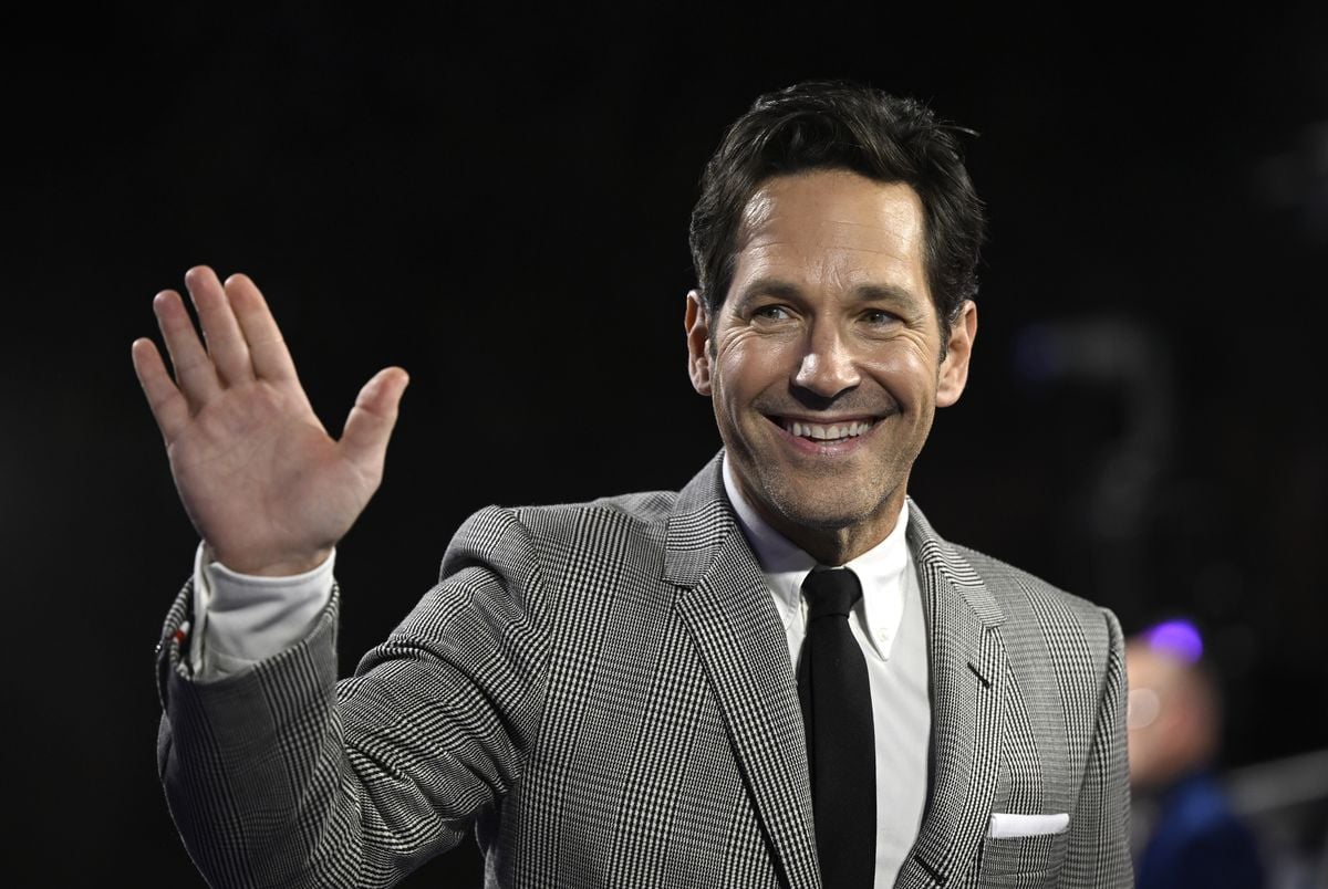 Paul Rudd smiles and waves to the camera.