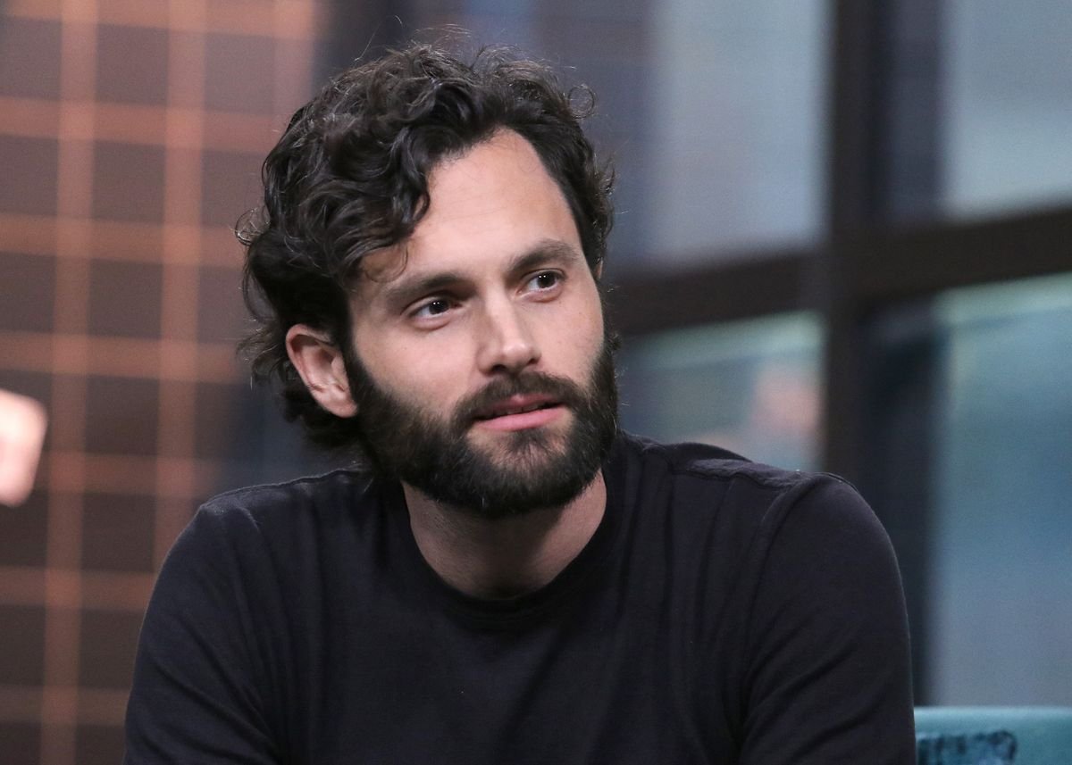 Penn Badgley answers questions on a talk show.