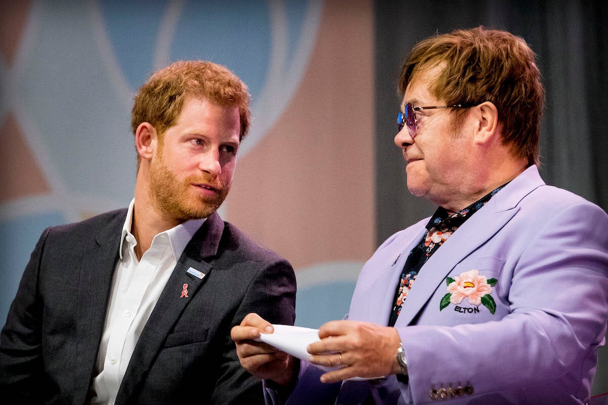 Prince Harry, whose son, Archie, became obsessed with a painting that had a connection to Princess Diana at Tyler Perry's house, sits with Elton John