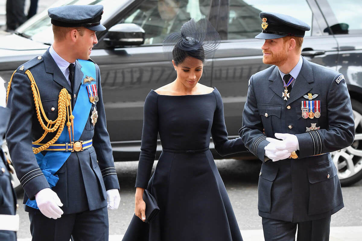Meghan Markle, who told Prince William to 'kindly take your finger out of my face,' walks with Prince William and Prince Harry