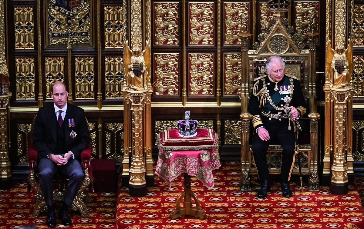 Prince William and King Charles III sit by the The Imperial State Crown in the House of Lords Chamber
