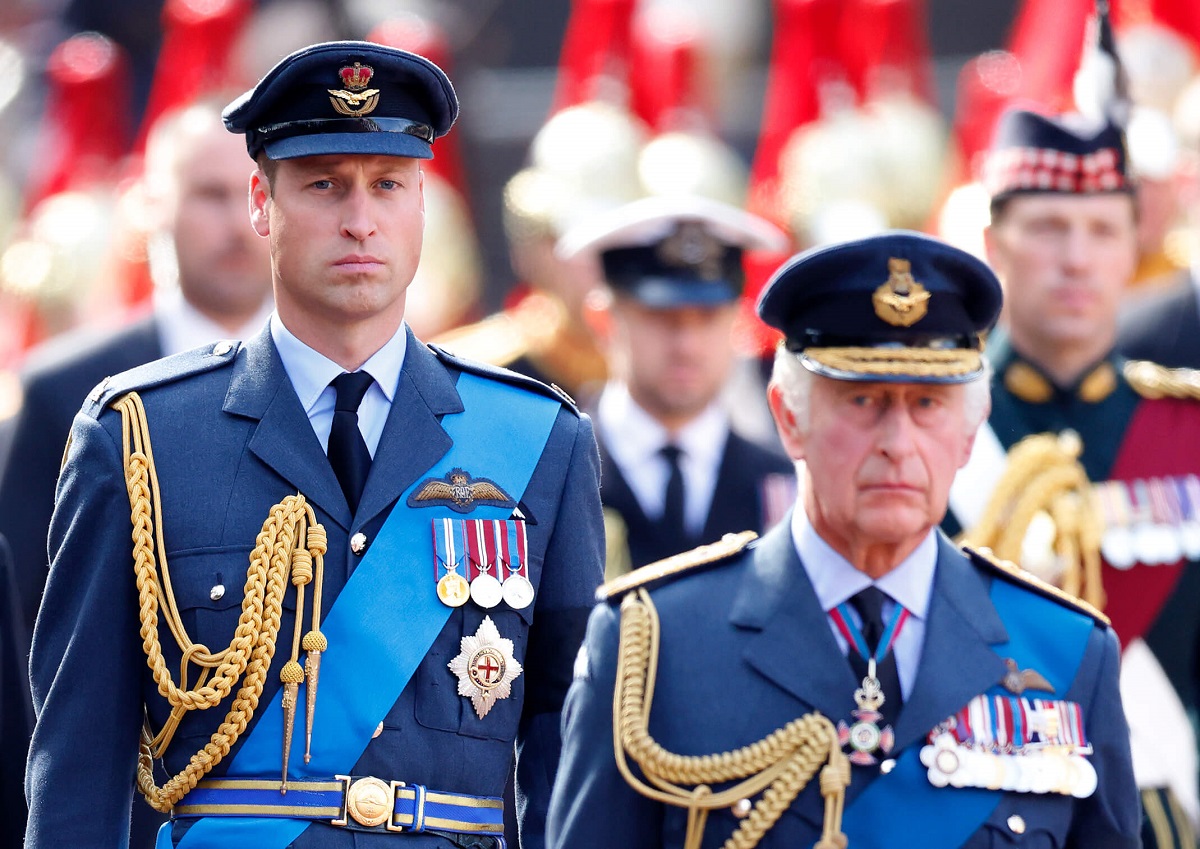Prince William and King Charles III walk behind Queen Elizabeth II's coffin as it is transported on a gun carriage