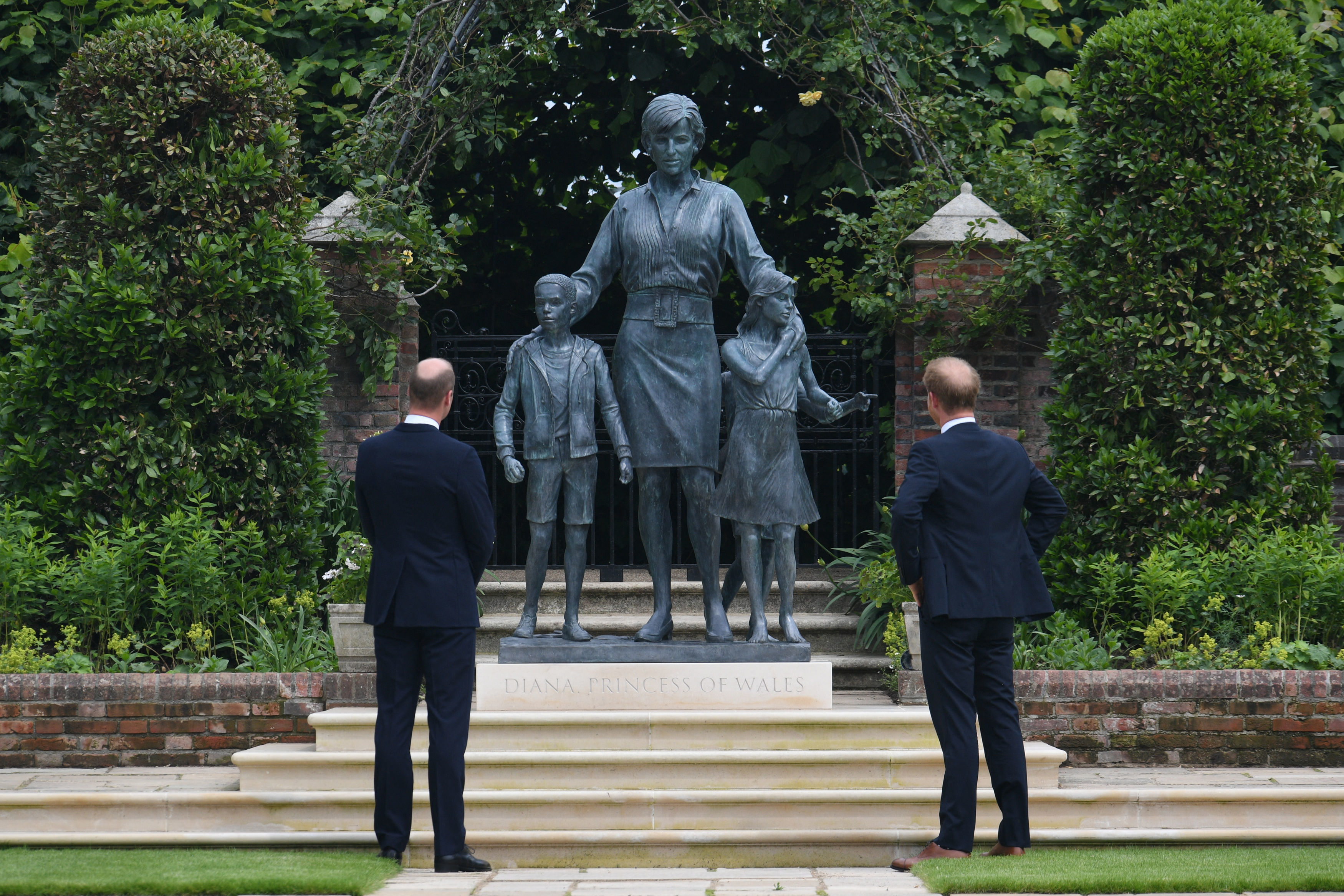 Prince William and Prince Harry unveil a statue of their mother, Princess Diana, at The Sunken Garden in Kensington Palace