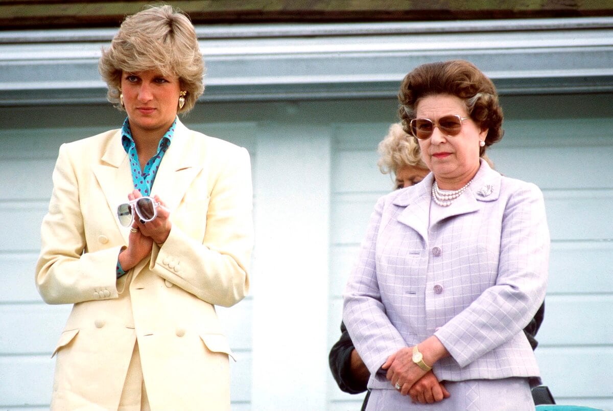 Princess Diana and Queen Elizabeth stand next to each other at an event.