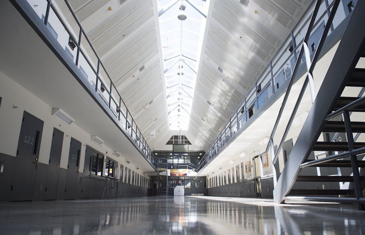 A prison cell block is shown empty