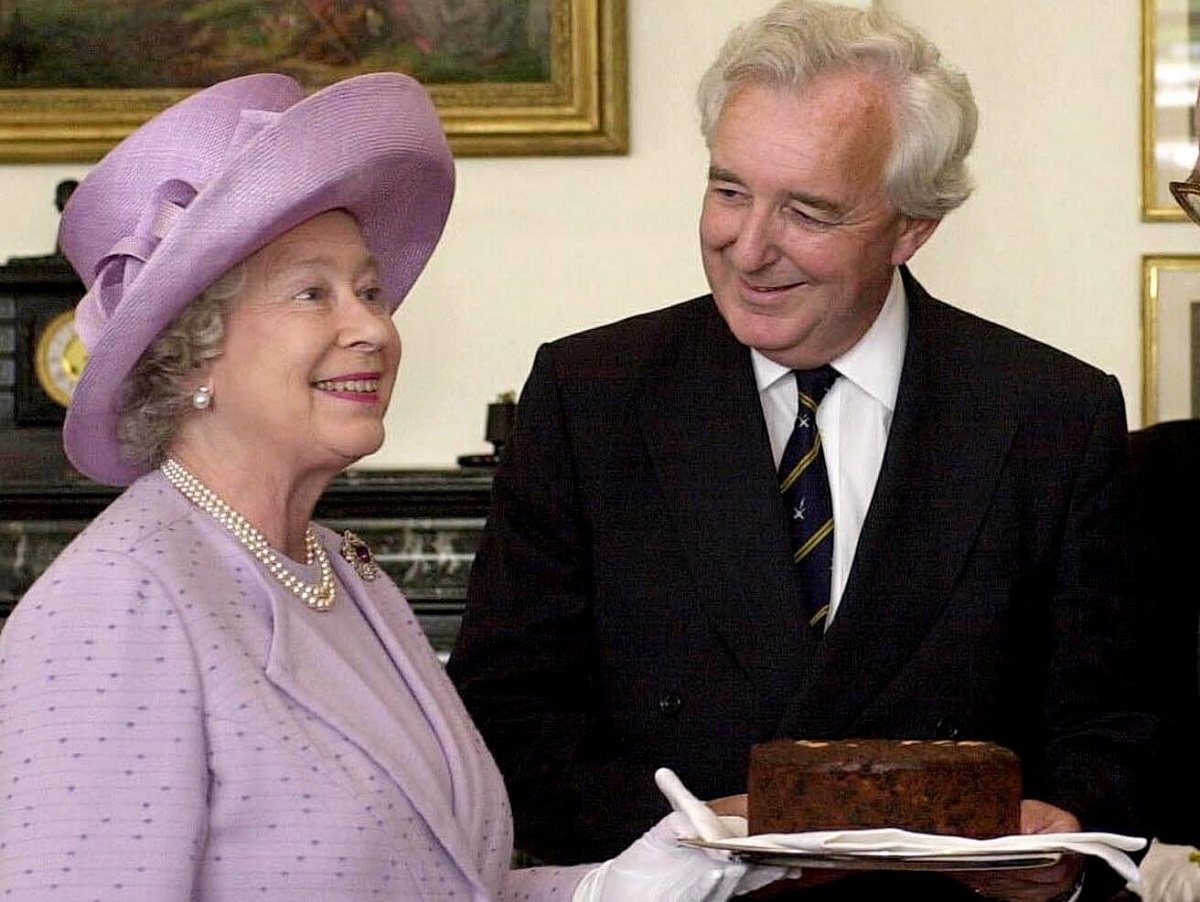Queen Elizabeth II presenting a cake to members of Radio Four's Test Match Special Commentary Team