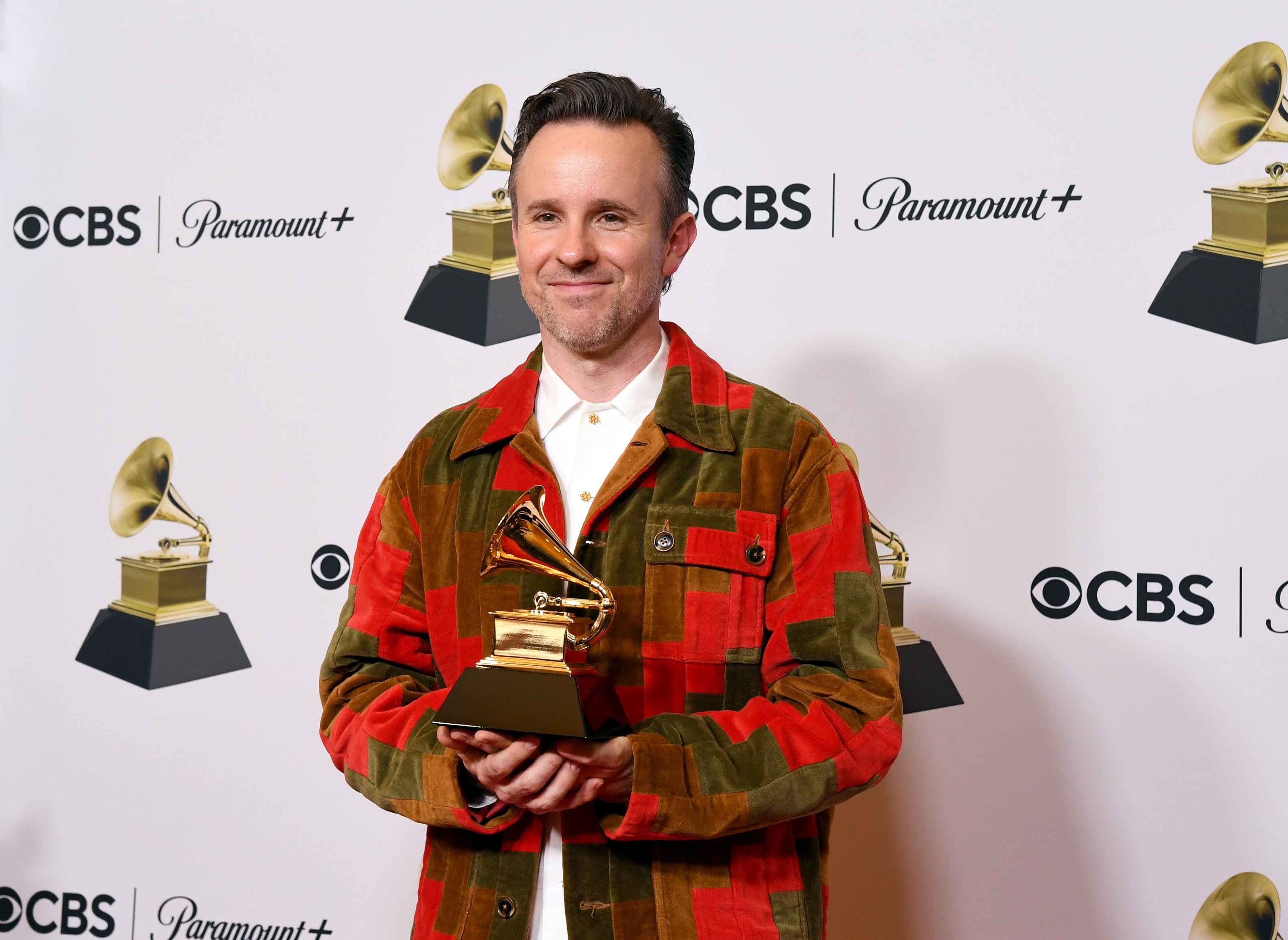 Ricky Reed holds up a Grammy Award