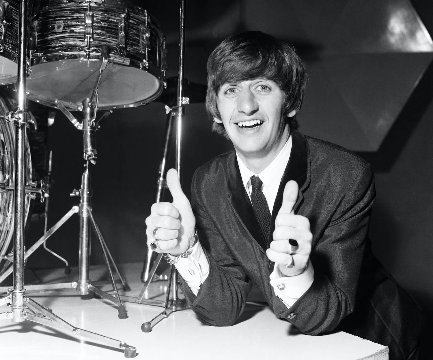 Beatles drummer Ringo Starr smiles while standing near his kit during a photo shoot on his 24th birthday on July 7, 1964.