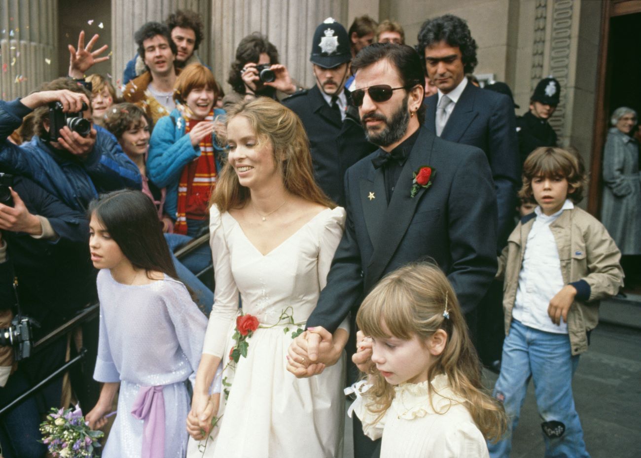 Ringo Starr and Barbara Bach hold hands after their wedding. They walk with their children Francesca Gregorini and Lee Starkey. 