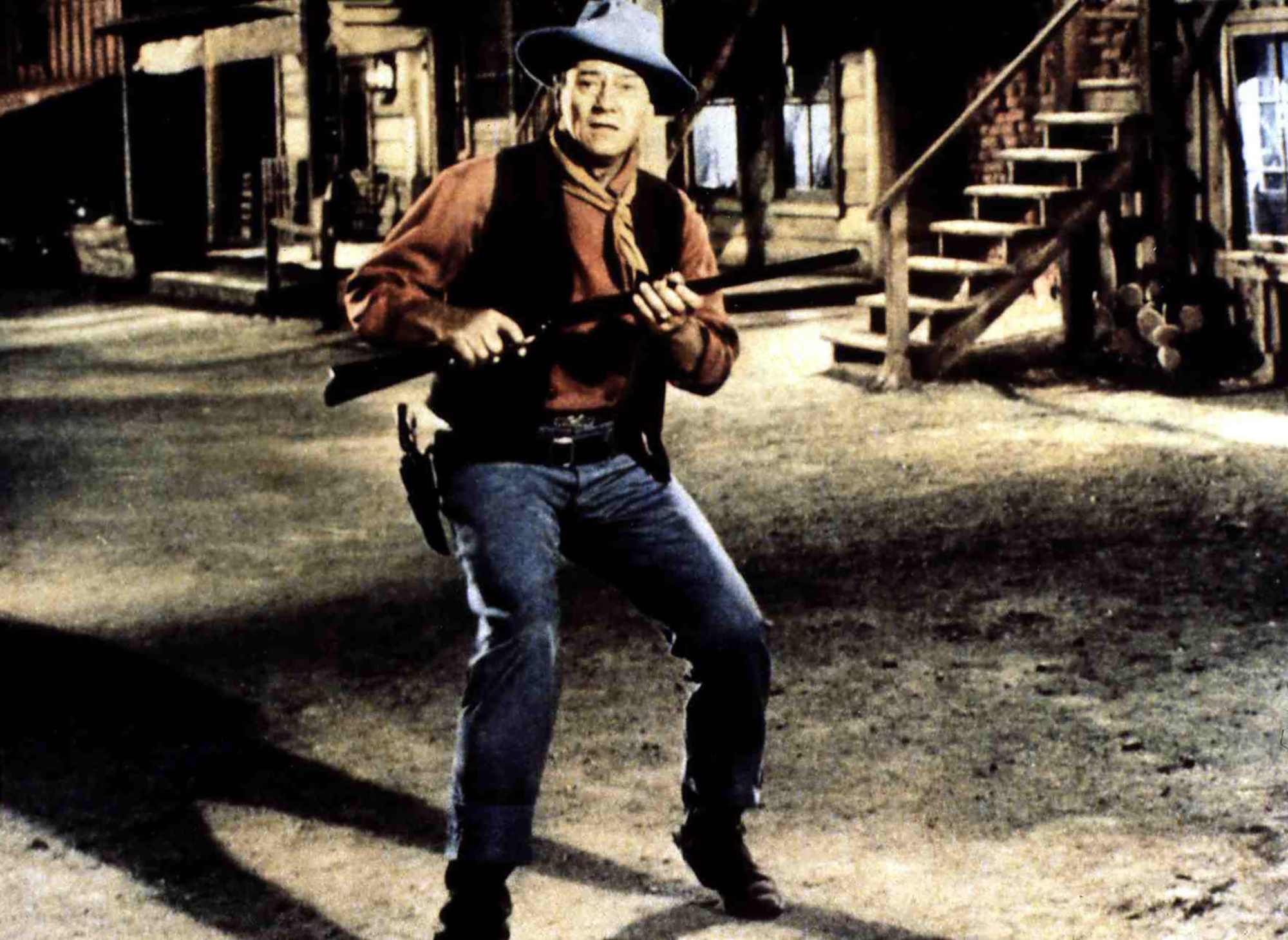'Rio Bravo' John Wayne as Sheriff John T. Chance holding his gun wearing a Western costume looking surprised