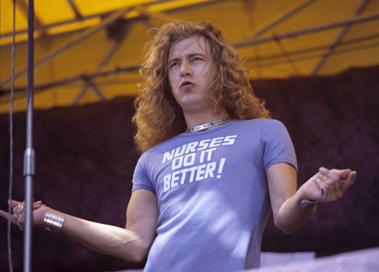 Led Zeppelin singer Robert Plant performs in a 'Nurses Do It Better' T-shirt at a 1977 concert in Oakland, California.
