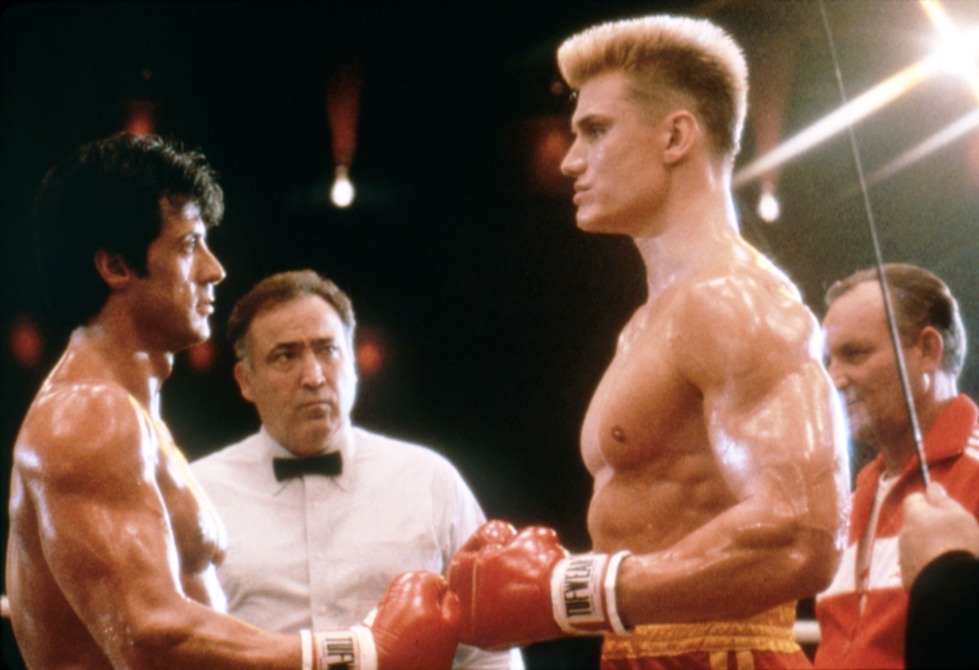 'Rocky IV' Sylvester Stallone as Rocky and Dolph Lundgren as Ivan Drago holding their boxing gloves against each other's.