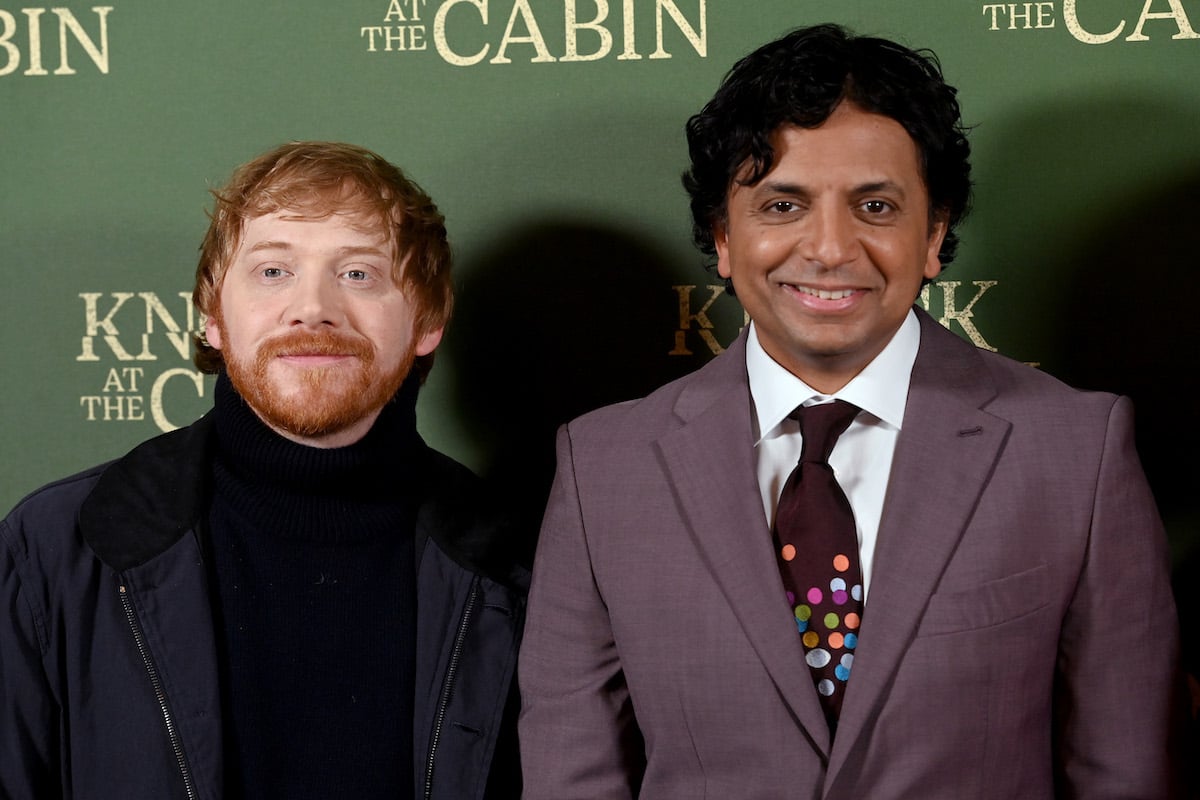 Rupert Grint and M. Night Shyamalan pose for photos at a screening of "Knock at the Cabin"