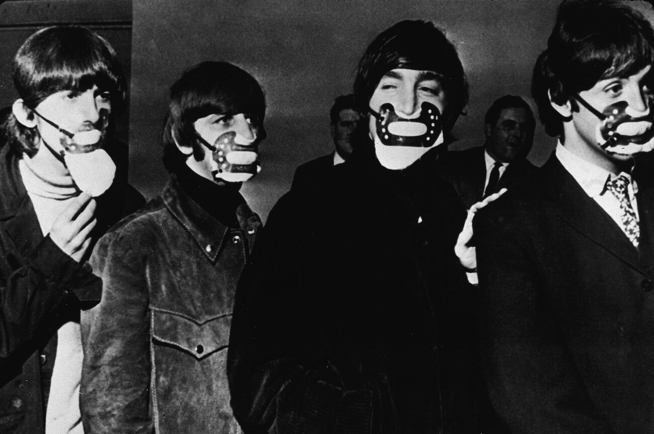 The Beatles wearing masks before a concert in 1965. 