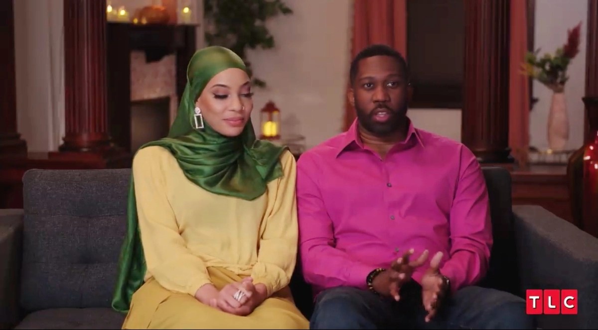 Shaeeda Sween and Bilal Hazziez sitting together on the couch during an interview for '90 Day Fiancé: Happily Ever After?' Season 7 on TLC.