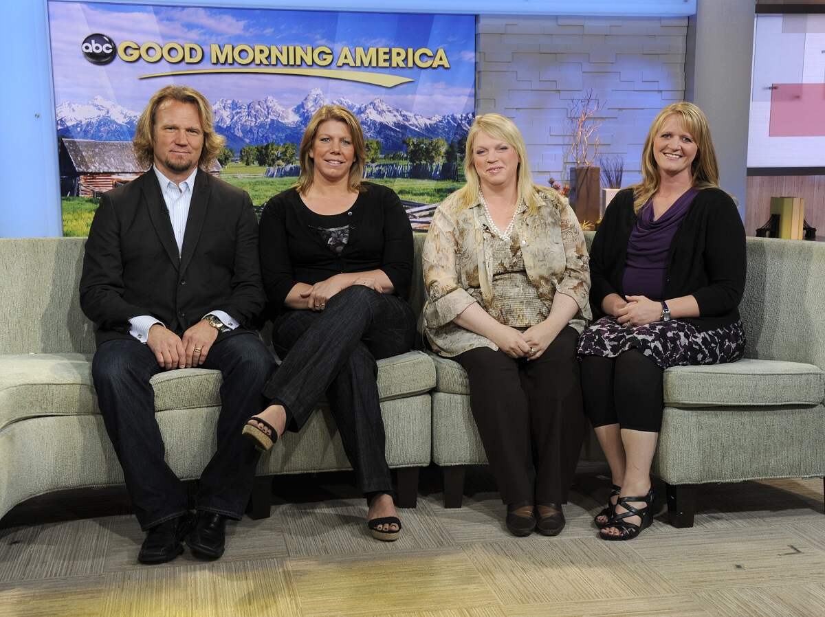 Kody Brown and his three former wives, Meri Brown, Janelle Brown and Christine Brown, sit in front of the 'Good Morning America' logo during an appearance on the show in 2011