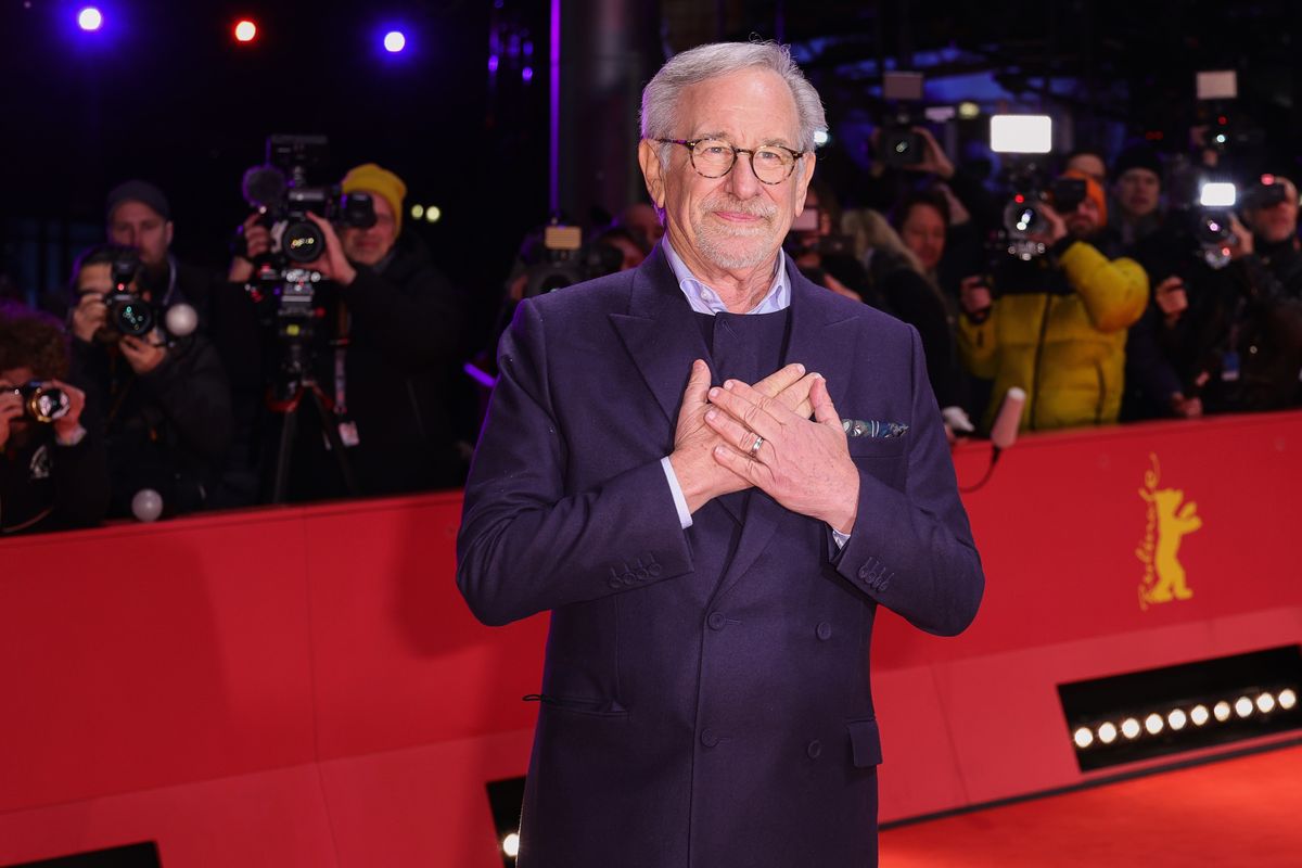 Steven Spielberg poses for photos on a red carpet during a premiere for "The Fablemans"