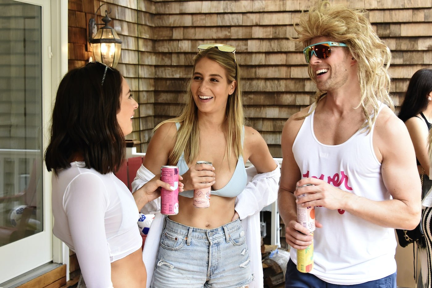 Paige DeSorbo, Amanda Batula, Kyle Cooke from 'Summer House' talk during a party
