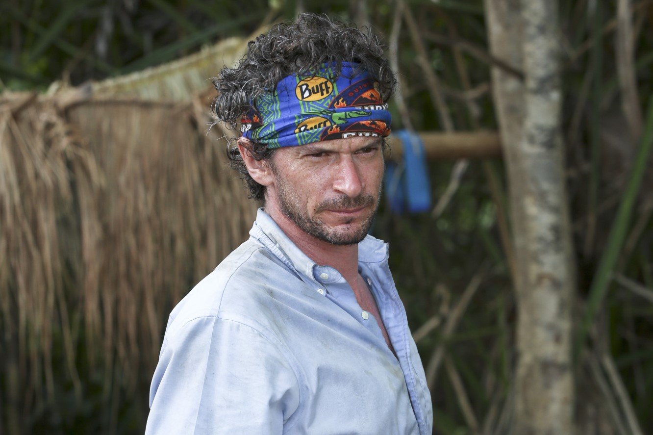 Neal Gottlieb, who starred in 'Survivor' Season 32 on CBS, wears a light blue button-up shirt and his dark blue 'Survivor' buff around his head.