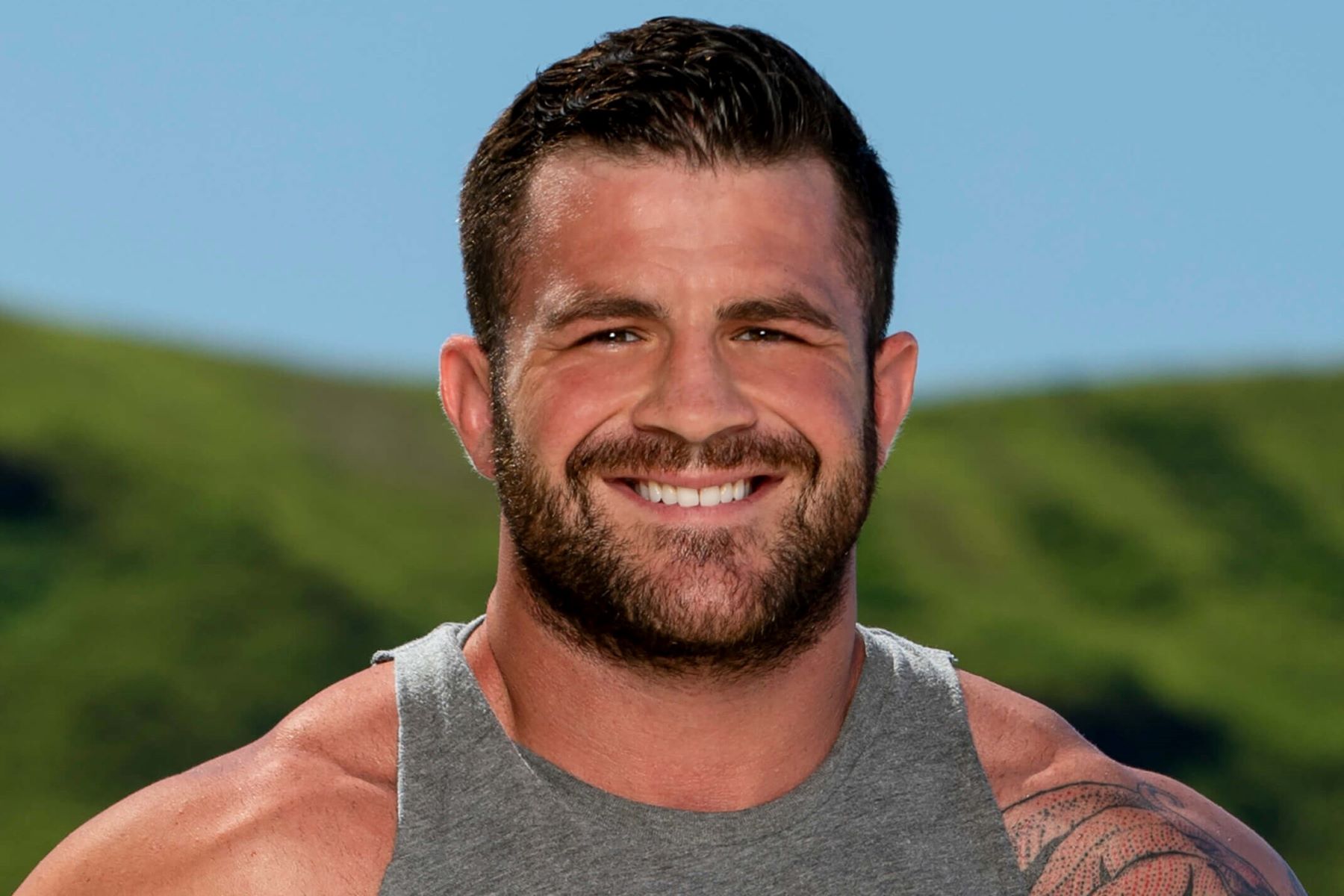 Danny Massa, who stars in 'Survivor' Season 44, wears a gray tank top.