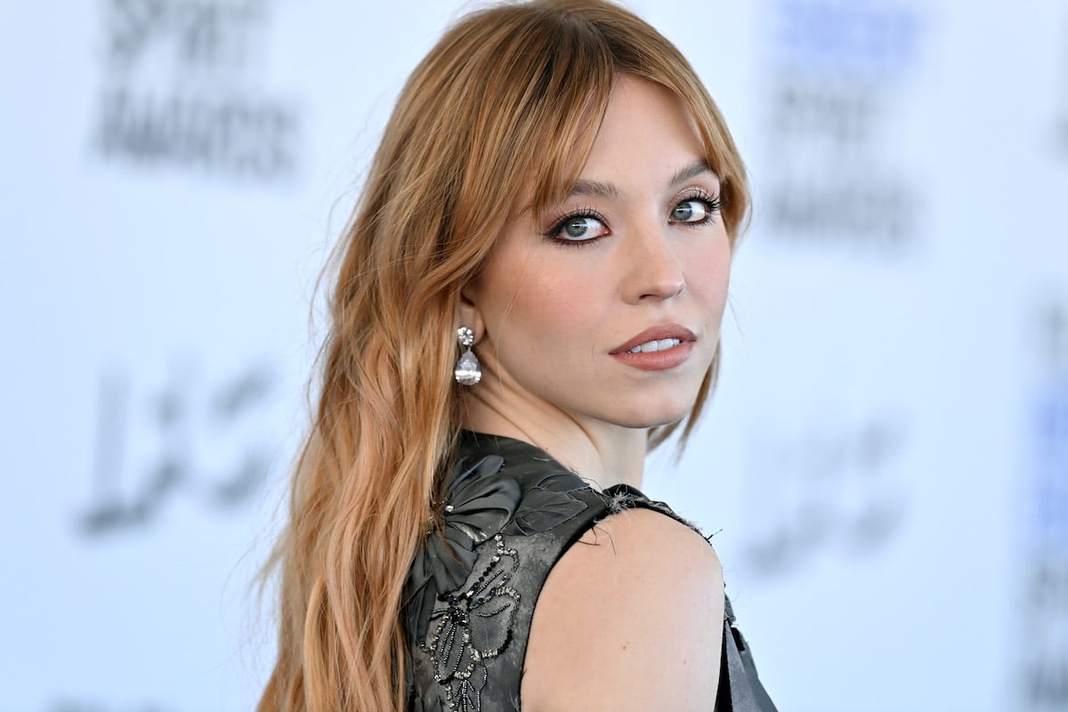 Sydney Sweeney poses for fans and photographers in a dress on the red carpet