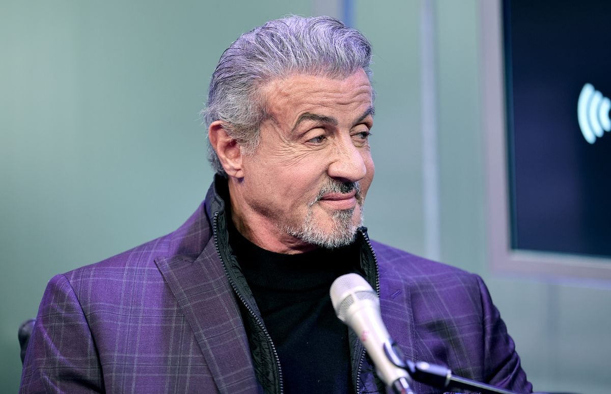 Sylvester Stallone speaks into a microphone