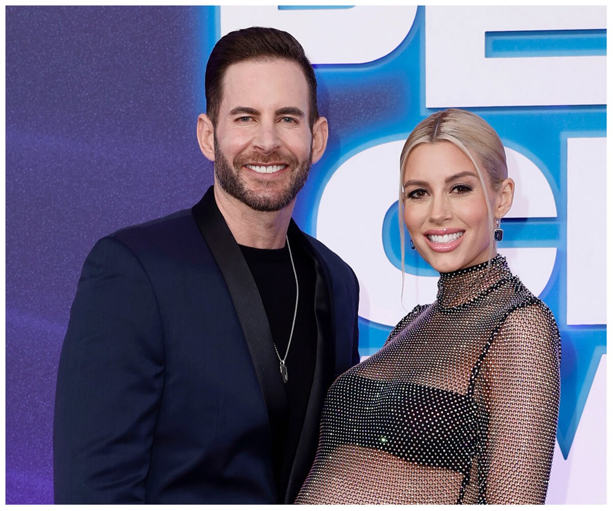 Tarek and Heather Rae El Moussa smile and pose together at an event.