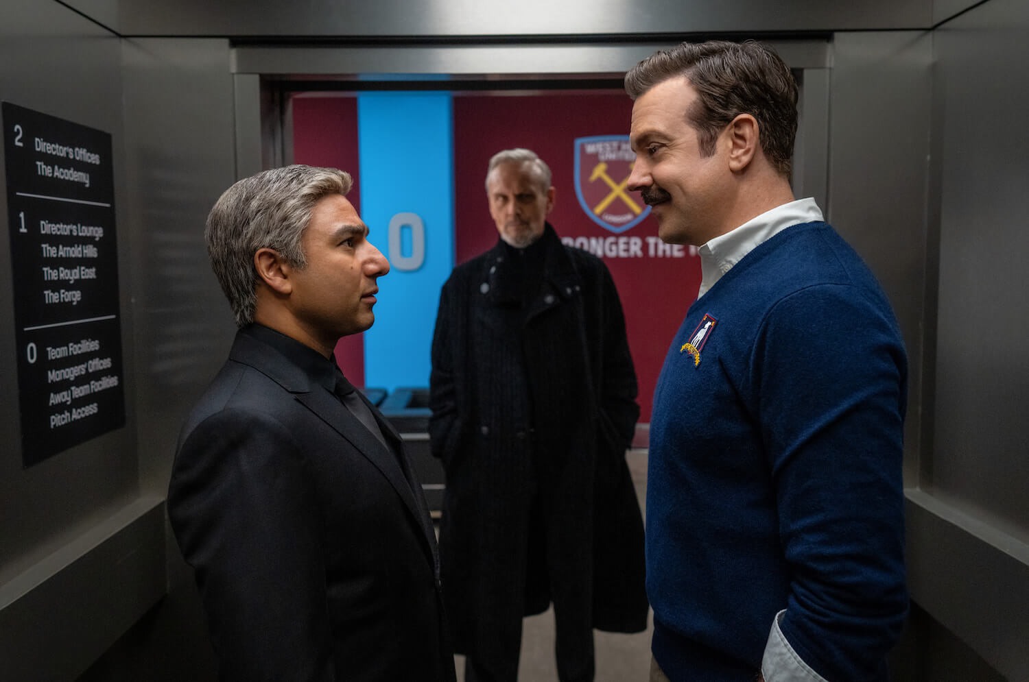 The 'Ted Lasso' Season 3 premiere date was announced on Feb. 14. In this production still Nick Mohammed and Jason Sudeikis look at one another in a hallway.