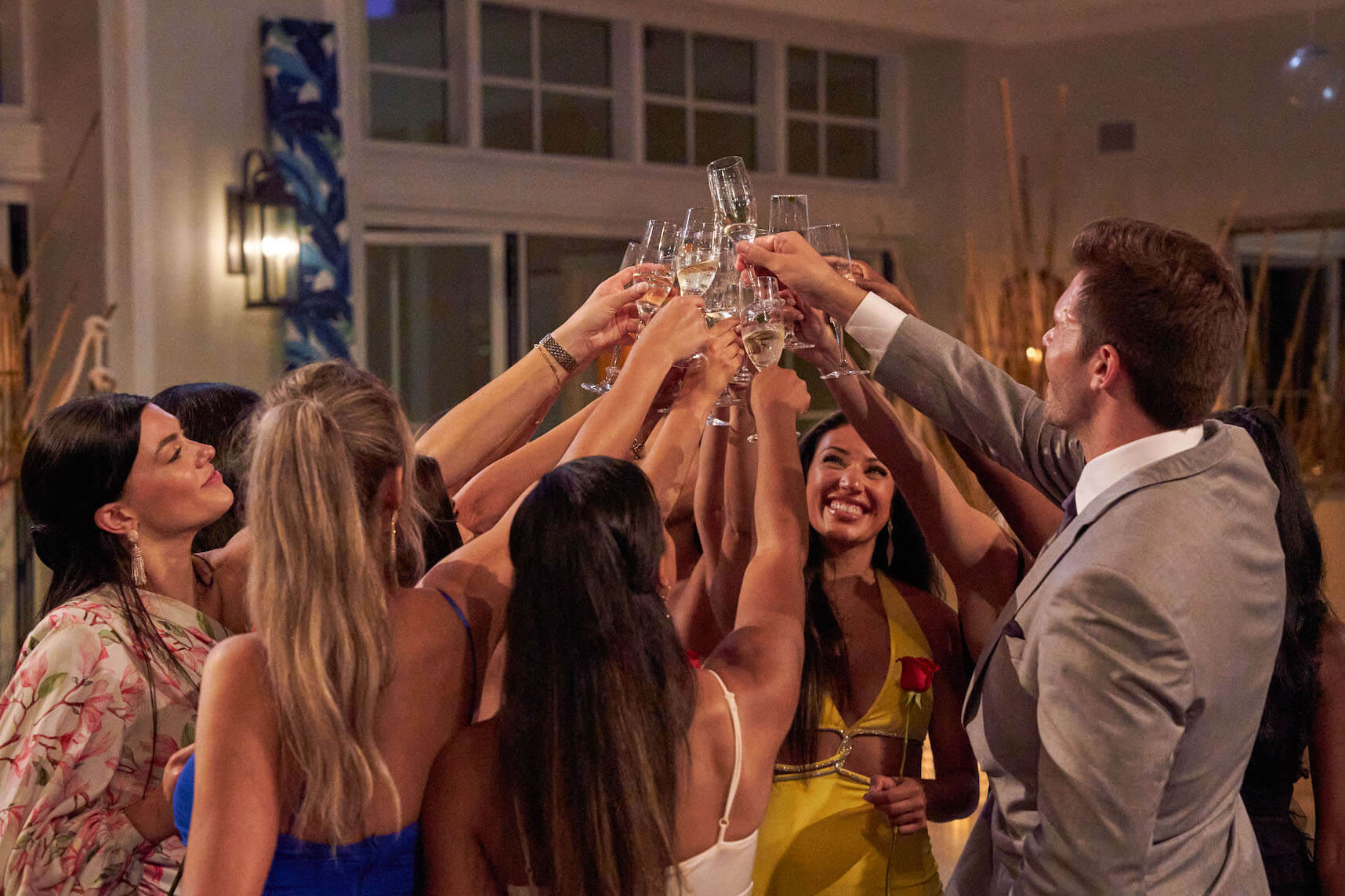 'The Bachelor' Season 27 cast raising their glasses up and toasting with Zach Shallcross