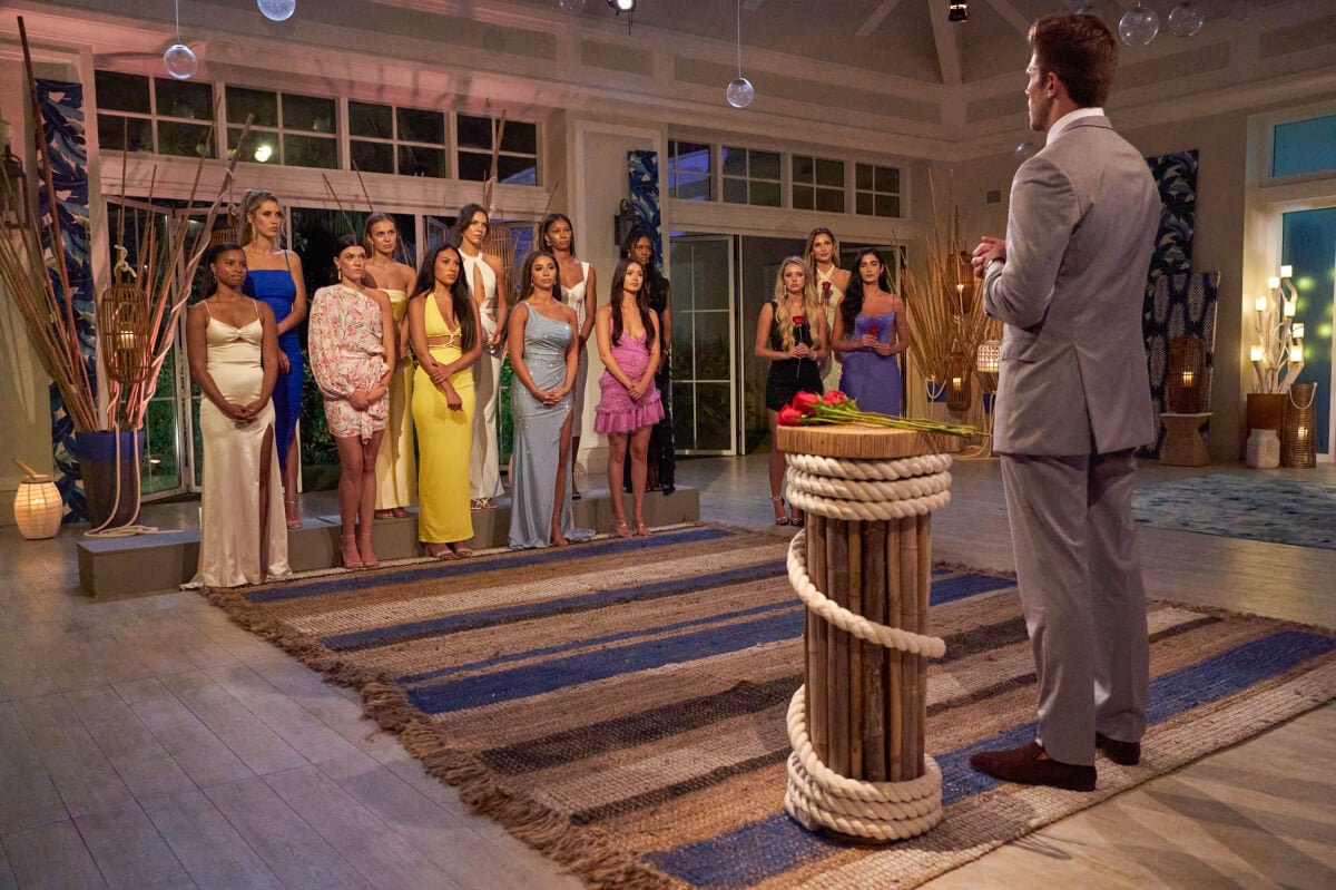 At a rose ceremony in The Bahamas, The Bachelor Zach Shallcross prepares to hand out roses to his 13 remaining contestants.