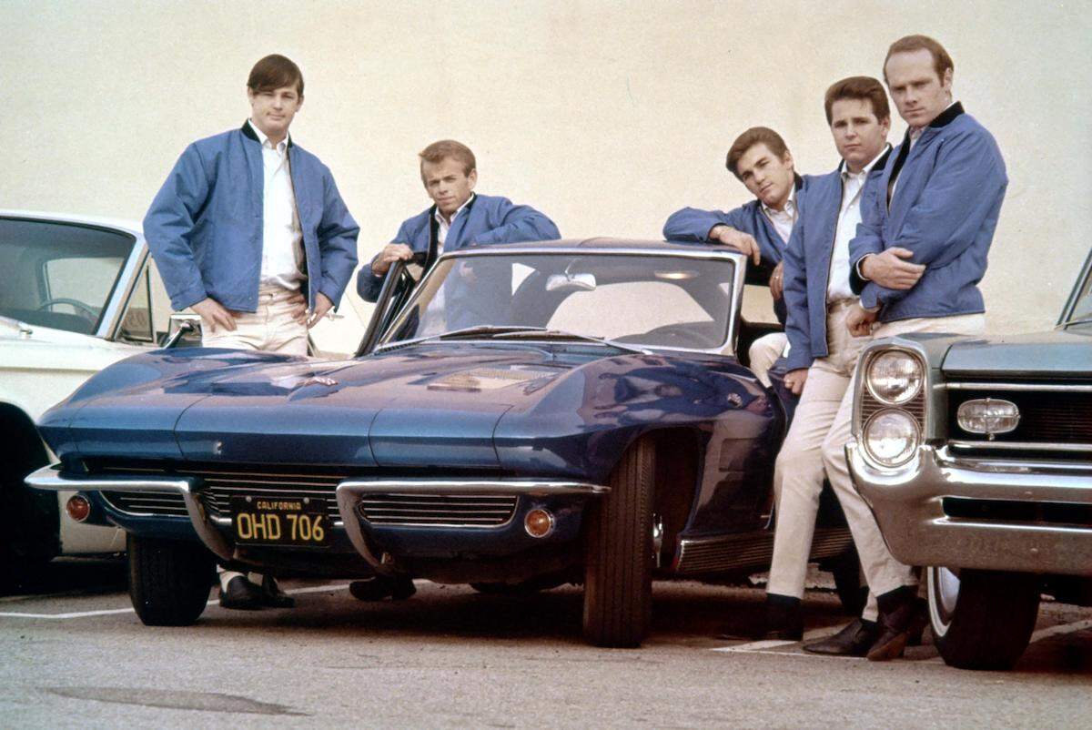 Rock and roll group The Beach Boys pose with a Corvette in Novermber 1963