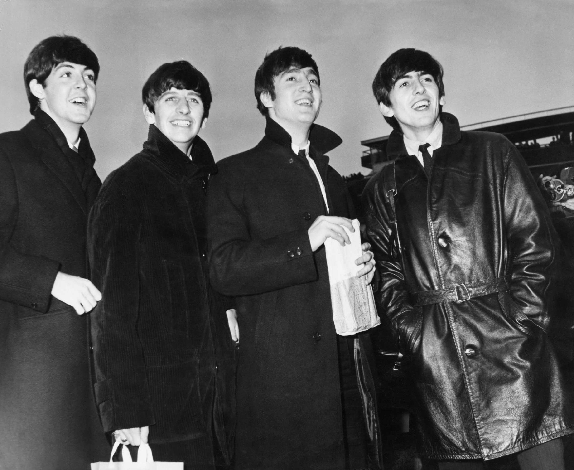 The Beatles return to the U.K. after a tour of Sweden