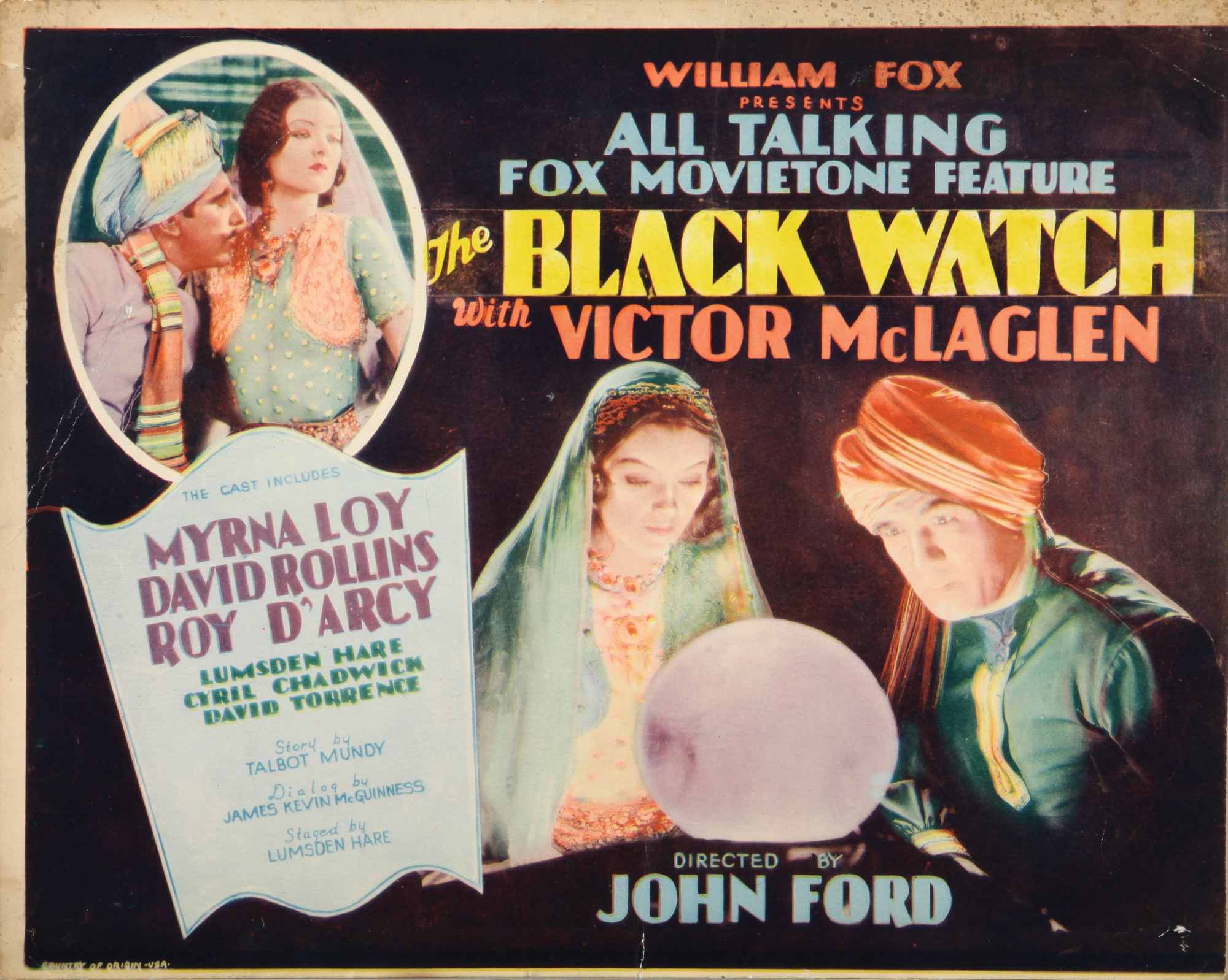 'The Black Watch' Myrna Loy as Yasmani and Victor McLaglen as Capt. Donald Gordon King looking into a bright globe