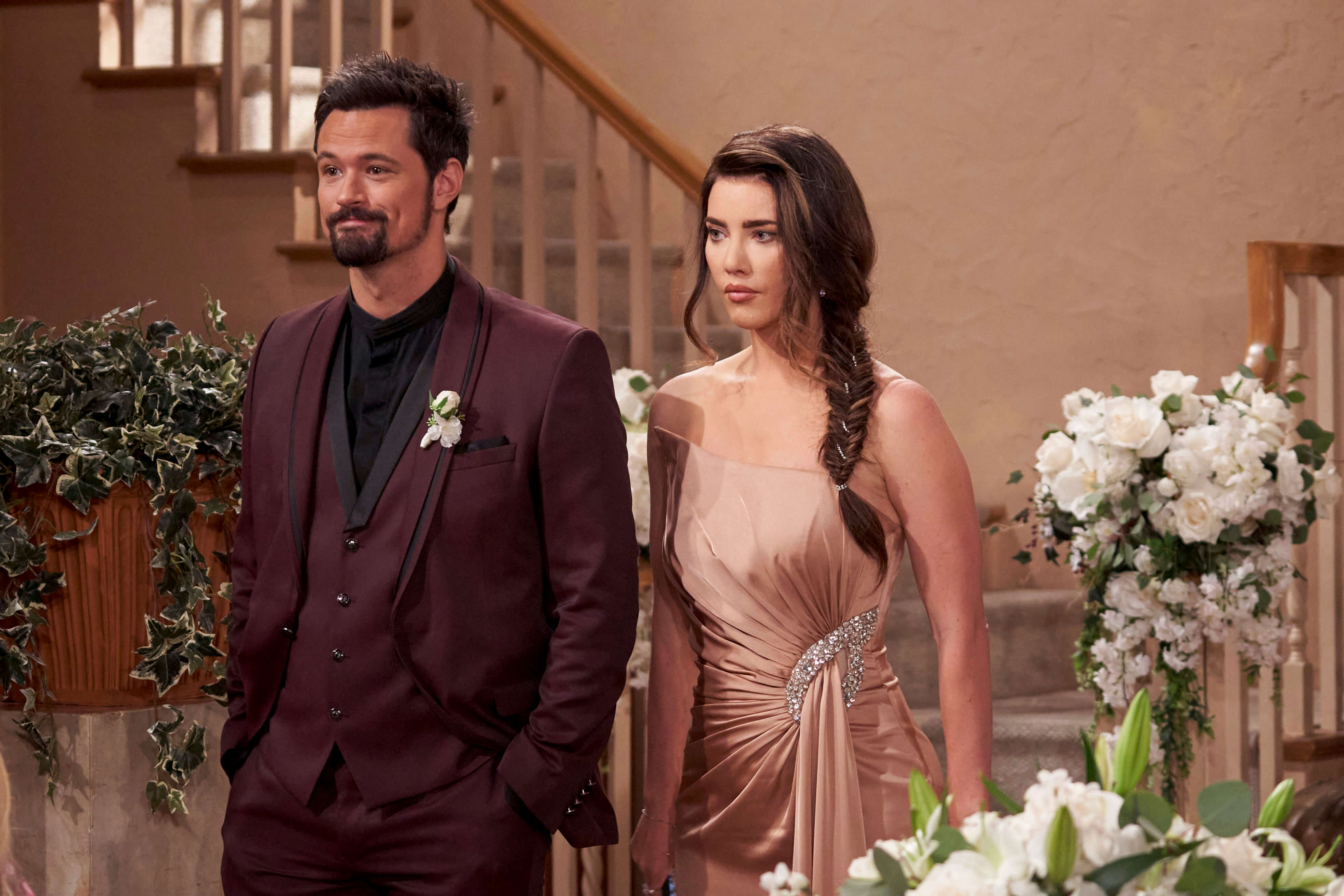'The Bold and the Beautiful' star Matthew Atkinson in a burgundy suit, and Jacqueline MacInnes Wood in a gold dress; in a scene from the soap opera.