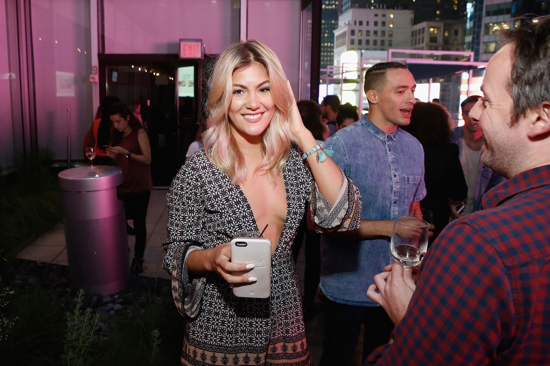 Tori Deal from MTV's 'The Challenge' Season 38 smiling at a party while holding her phone