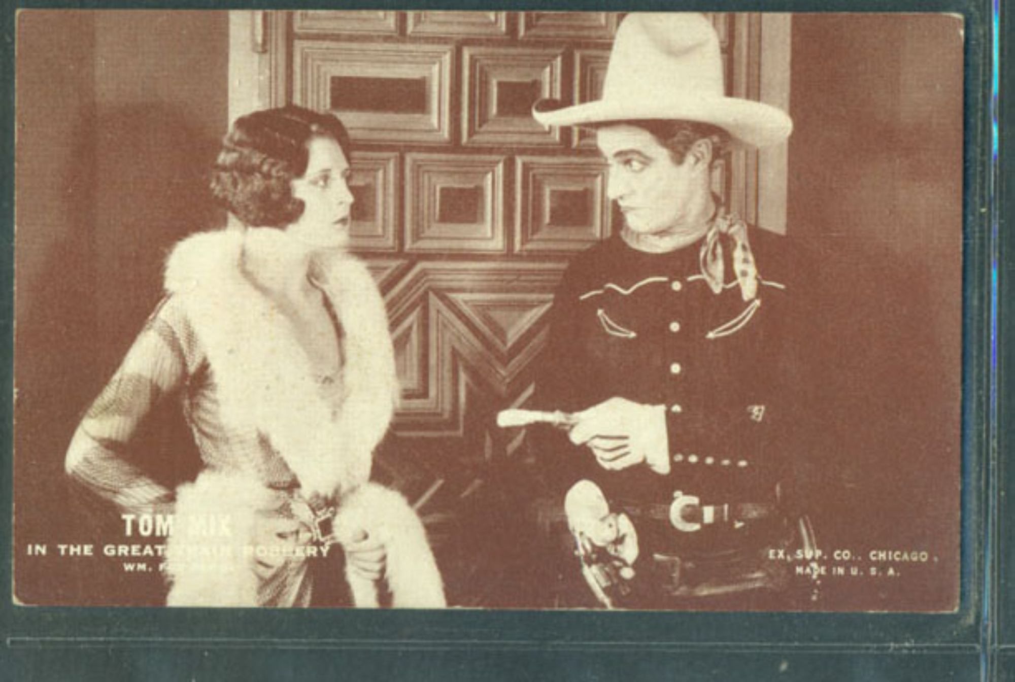 'The Great K & A Train Robbery' Dorothy Dwan as Madge Cullen and Tom Mix as Tom Gordon looking at each other in a sepia image