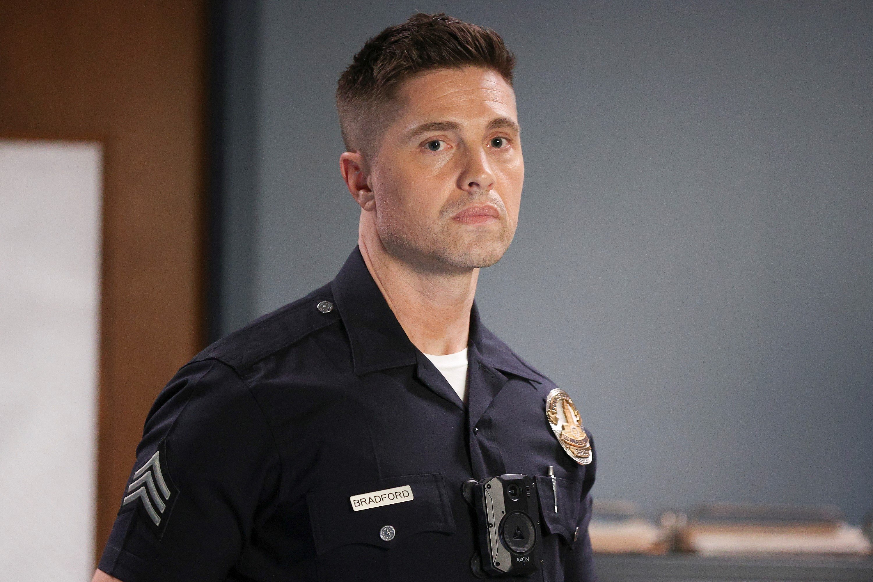 Eric Winter as Tim Bradford, who recently joined Metro, in 'The Rookie' on ABC. Tim wears his dark blue police uniform.