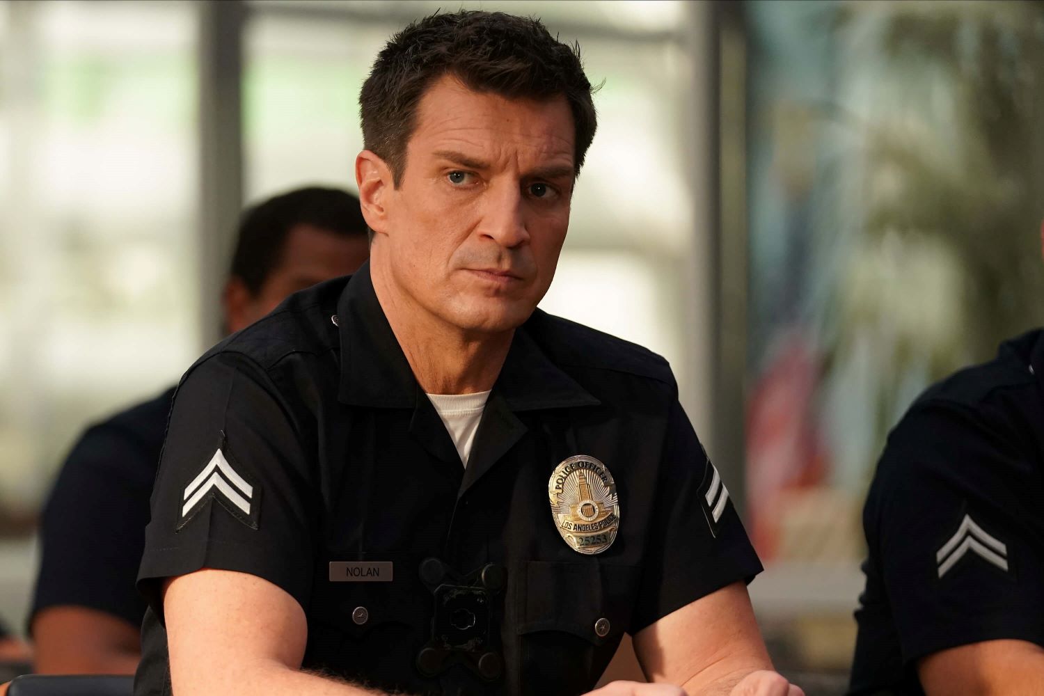 Nathan Fillion, in character as John Nolan in 'The Rookie' Season 5, wears his dark blue police uniform.