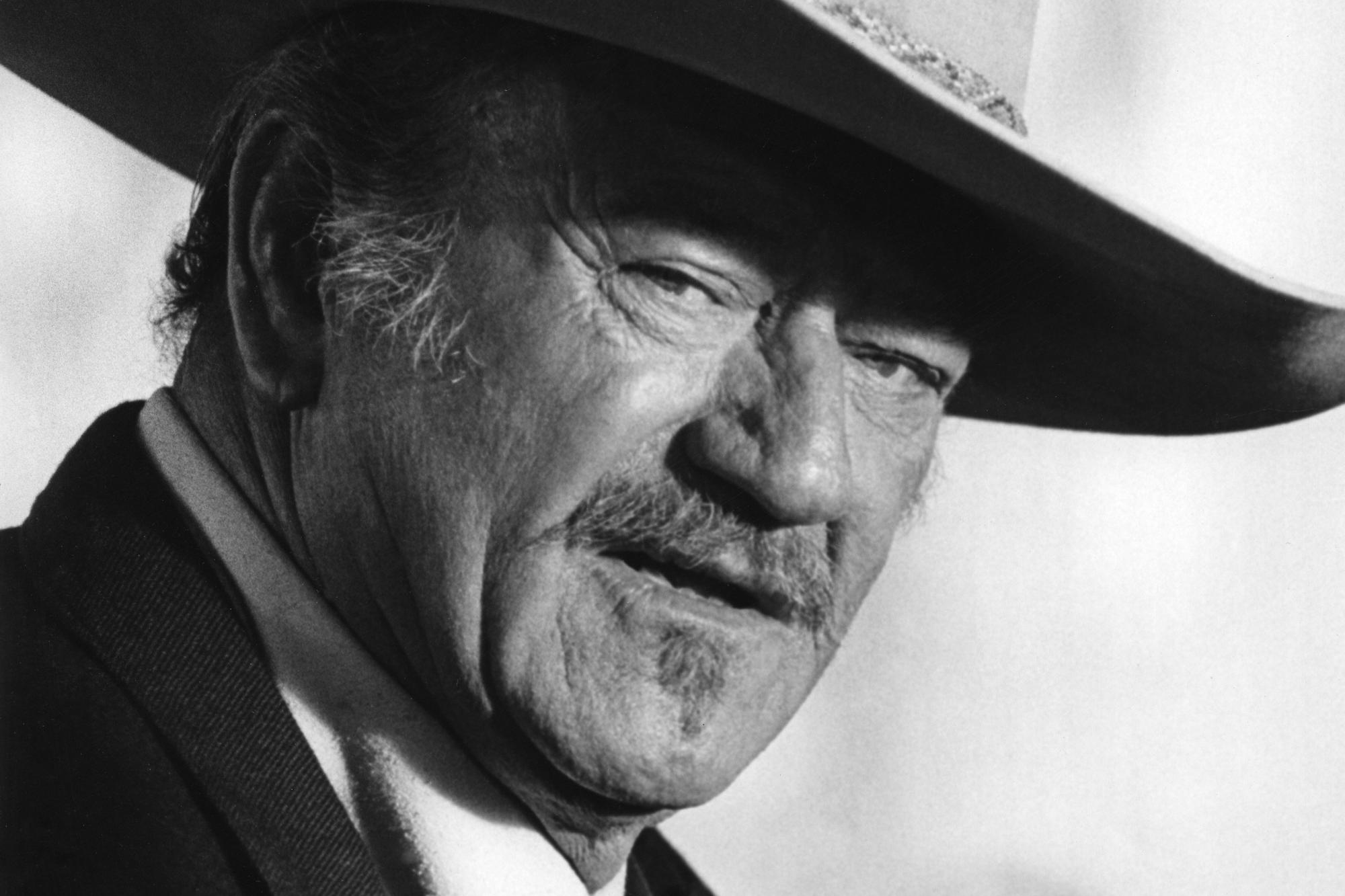 'The Shootist' John Wayne as J.B. Books in a black-and-white photo looking at the camera wearing a Western hat