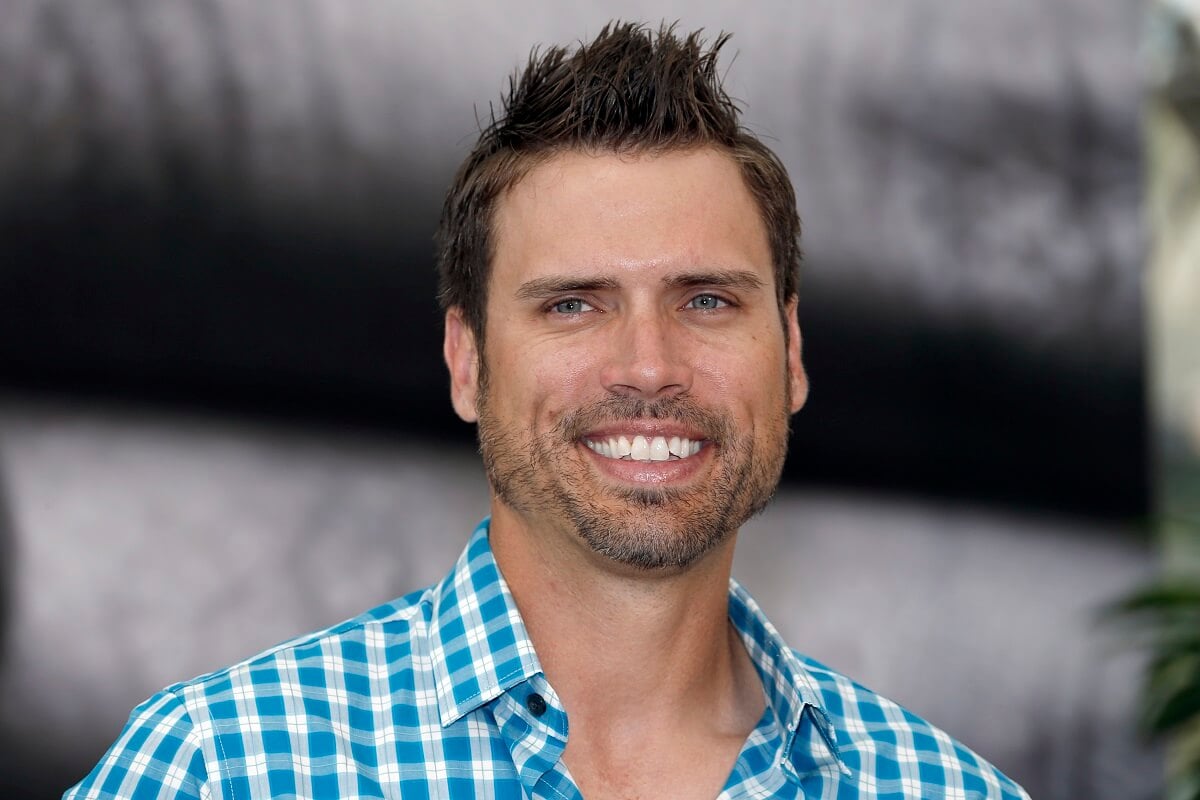 'The Young and the Restless' actor Joshua Morrow dressed in a blue and white shirt; poses on the red carpet.