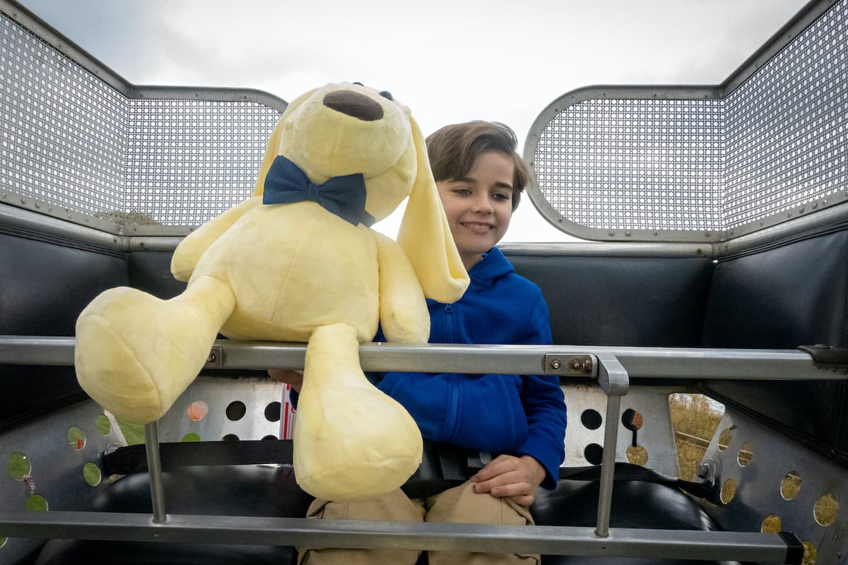 Jacob holding a stuffed animal on a Ferris wheel in Hallmark Channel's 'The Way Home'