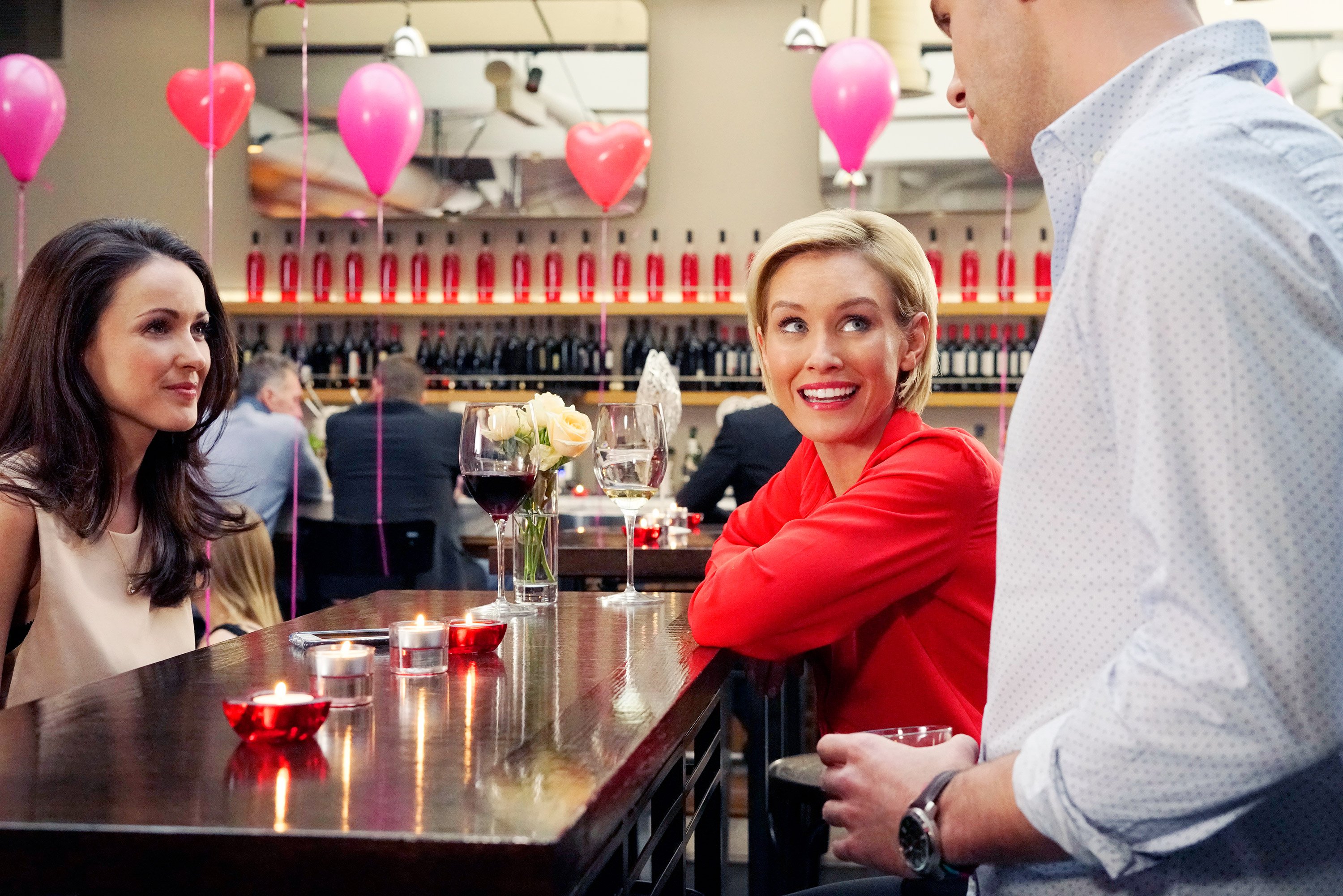 Two women sitting at a table with candles in the Valentine's Day movie 'Valentine's Again' from Hallmark Channel