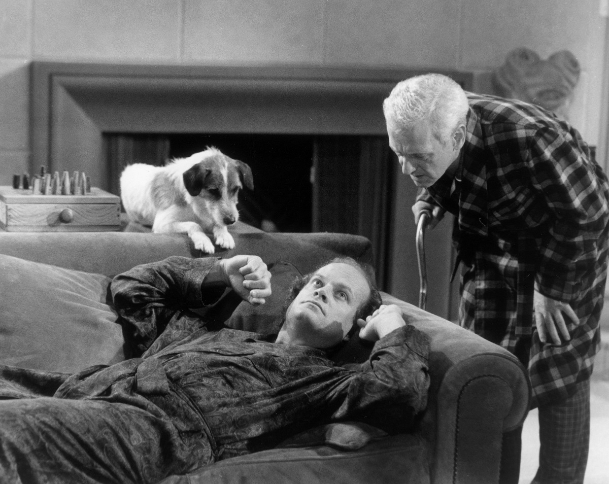 Eddie and Doctor Frasier Crane lay on the couch in Frasier's apartrment while Martin Crane stands over them in an episode of 'Frasier'