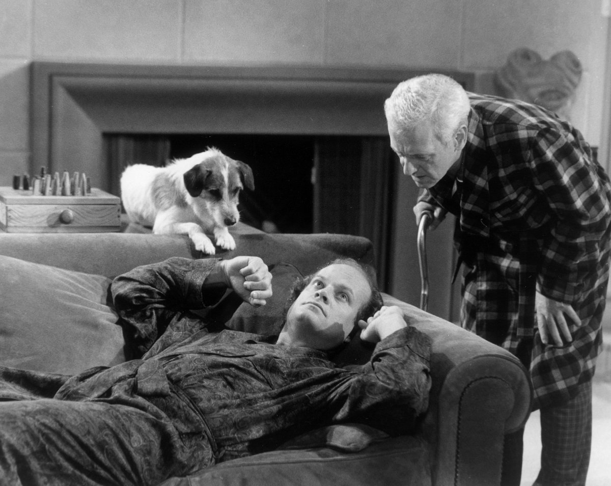 Eddie and Doctor Frasier Crane lay on the couch in Frasier's apartrment while Martin Crane stands over them in an episode of 'Frasier'