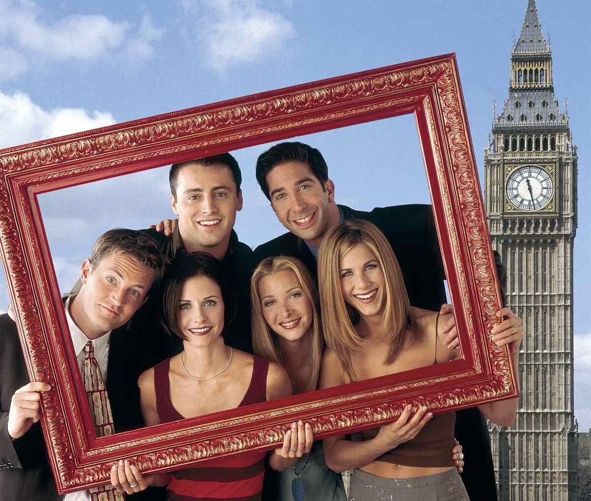 Matthew Perry as Chandler Bing, Matt Le Blank as Joey Tribbiani, David Schwimmer as Ross Geller, Jennifer Aniston as Rachel Green, Lisa Kudrow as Phoebe Buffay, and Courteney Cox as Monica Geller pose with a picture frame for a promotional photo for 'Friends'