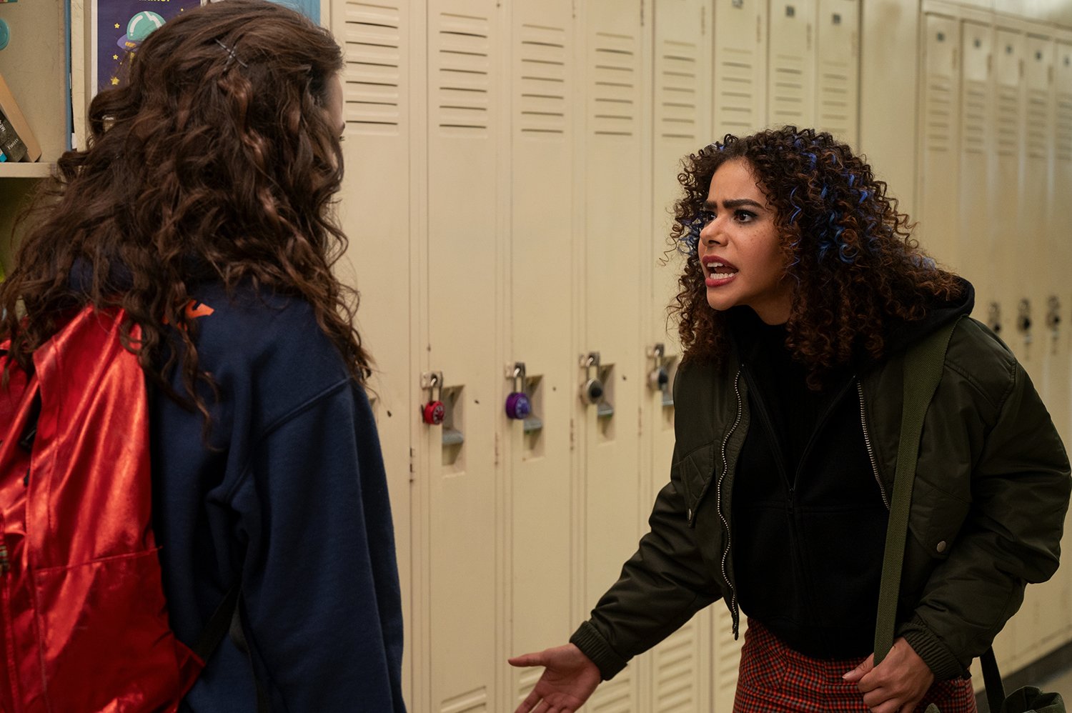 Ginny & Georgia Season 2: Sara Waisglass as Max and Anotina Gentry as Ginny yell at each other in a school hallway.
