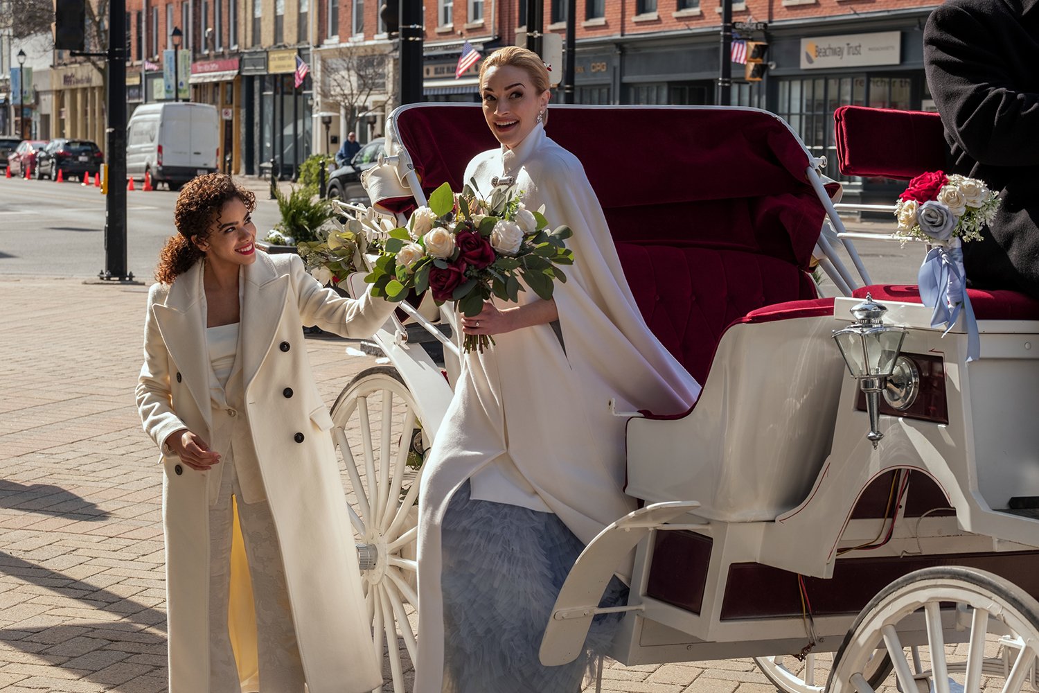 Antonia Gentry and Brianne Howey exit a horse-drawn carriage in Ginny & Georgia