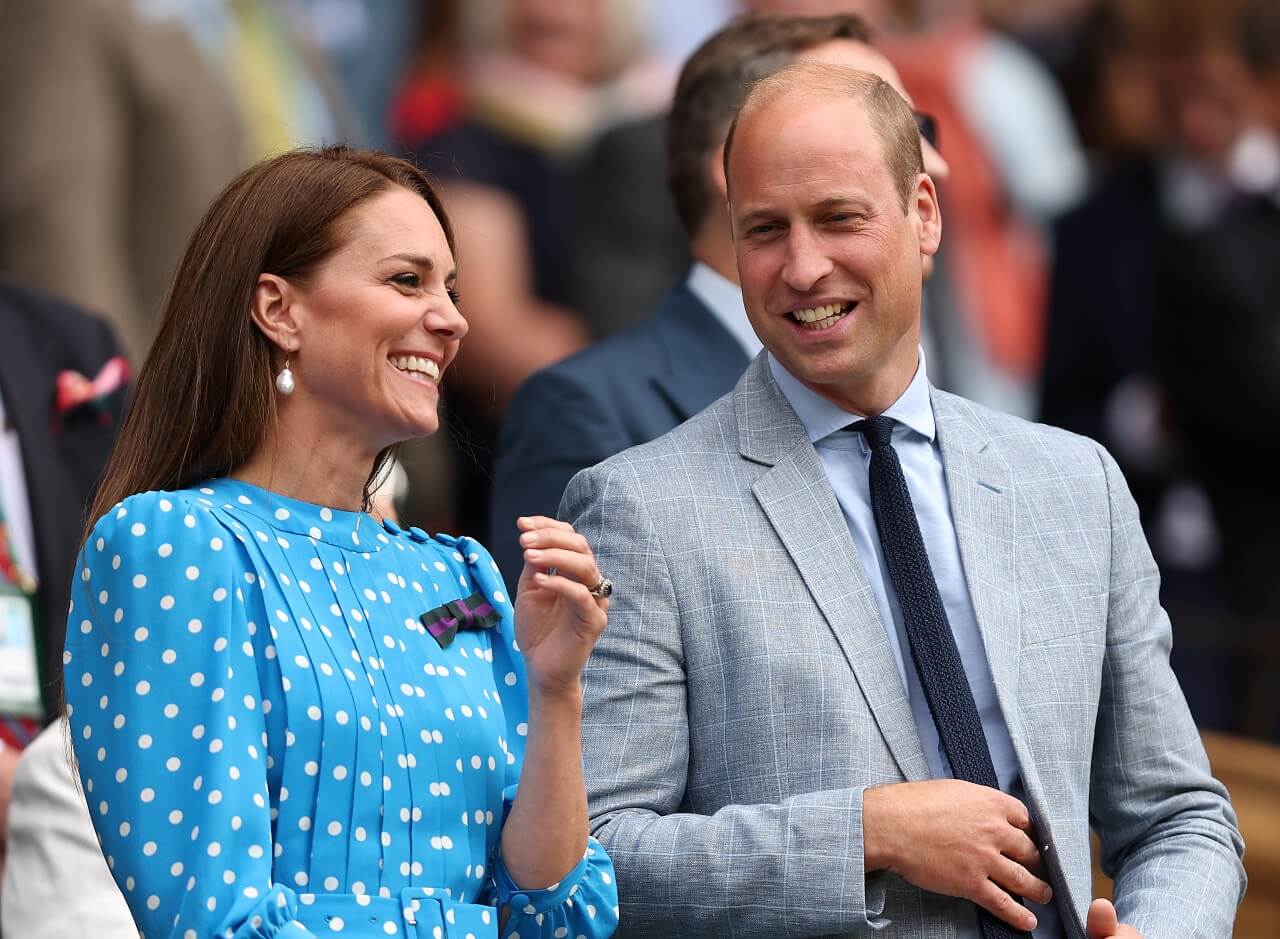 Kate Middleton and Prince William laugh together.