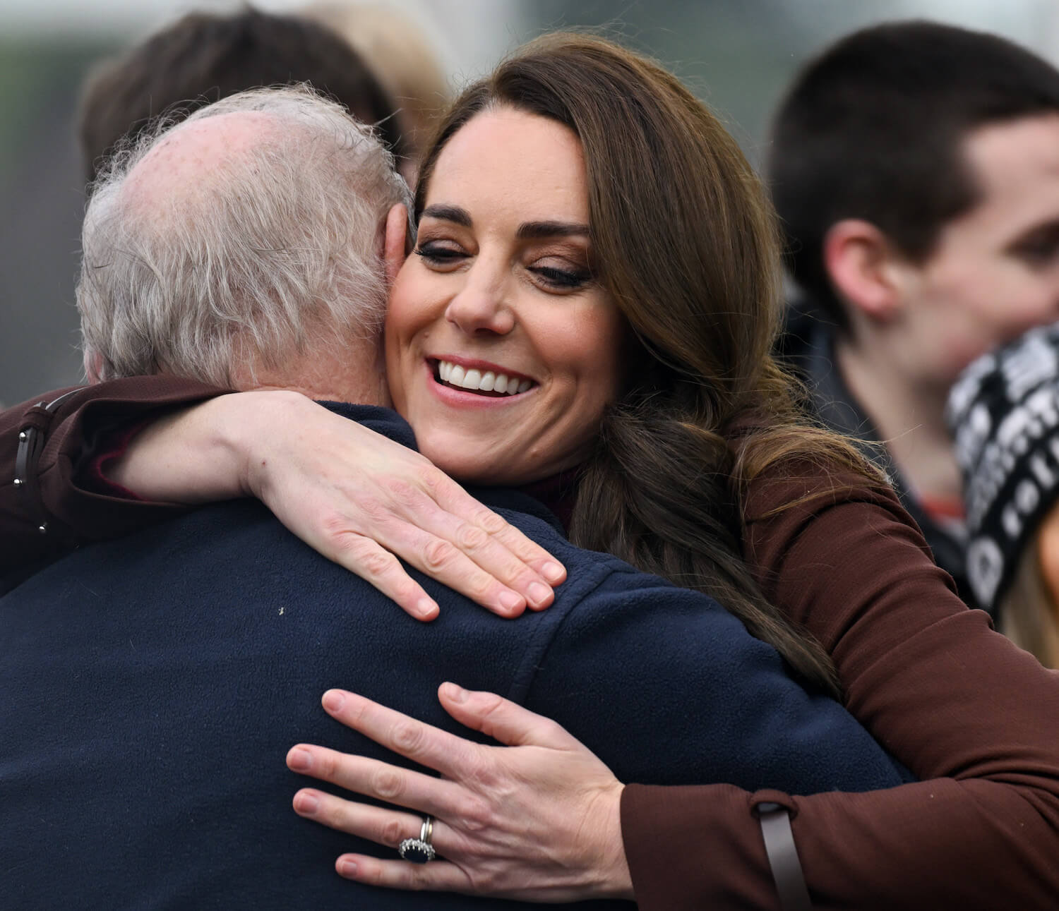 Kate Middleton displays a warm body language gesture, hugging Jim Embury during a visit to Cornwall